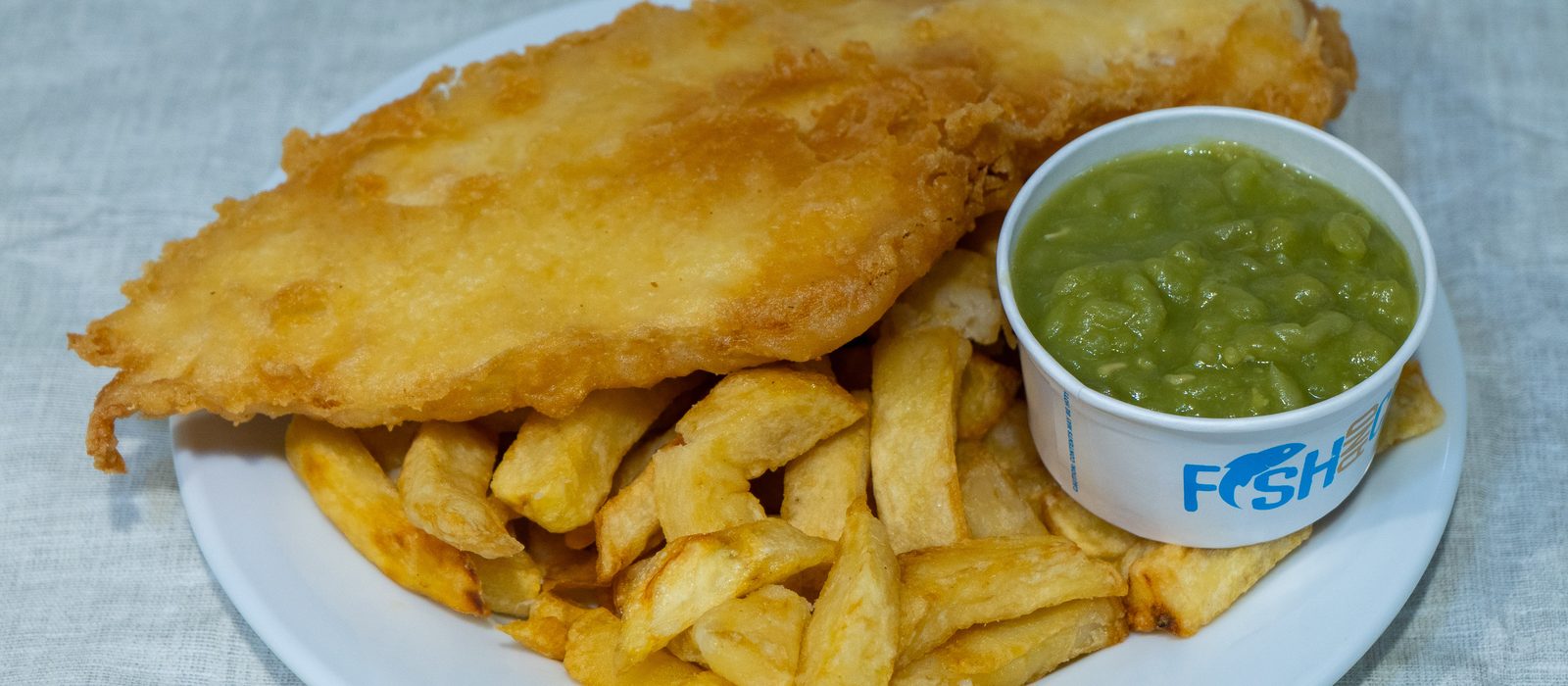Freshly battered fish with chips and mushy peas at Astill Lodge Chippy